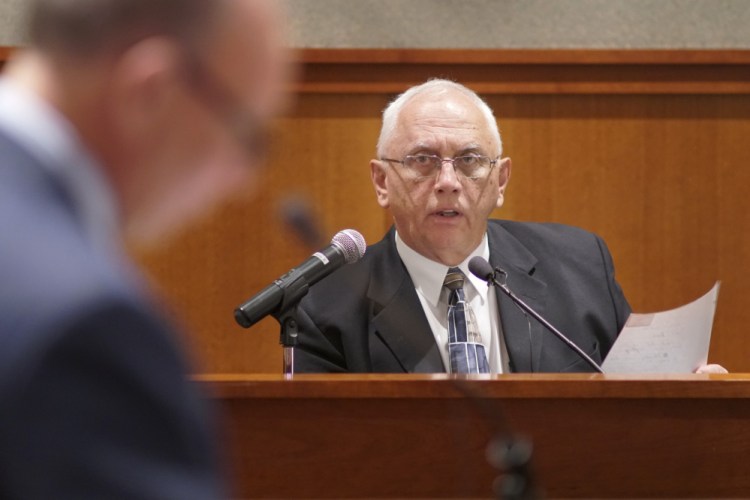 Retired Portland police Detective James Daniels answers questions from Assistant Attorney General Paul Rucha during a post-conviction review Tuesday for Anthony H. Sanborn Jr. at the Cumberland County Courthouse in Portland.