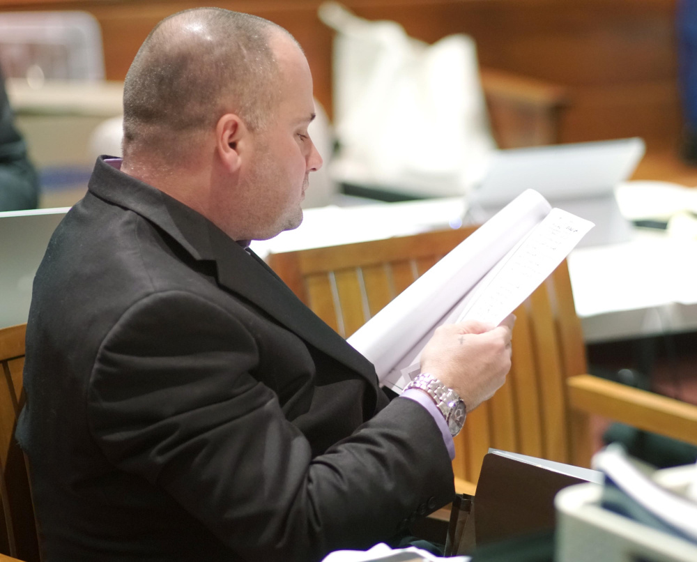 Anthony H. Sanborn Jr. looks over documents while listening to retired Portland police detective James Daniels answer questions from attorney Amy Fairfield during the 12th day of Sanborn's post-conviction review at the Cumberland County Courthouse on Wednesday.