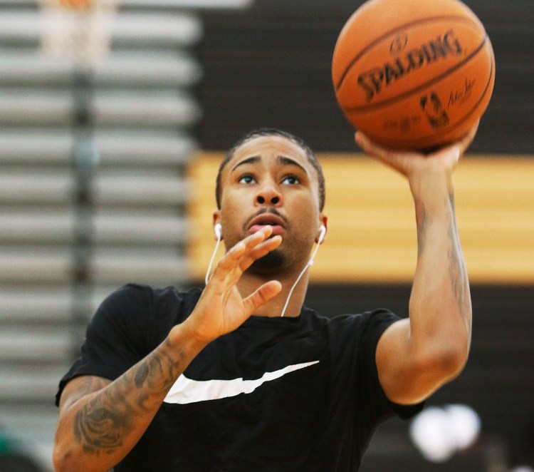 Trey Davis warms up for practice with the Red Claws on Monday at Scarborough High School. He's one of 11 players vying for six roster spots on the team.