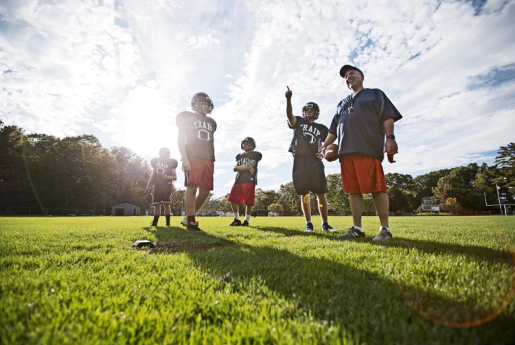 Traip Academy Coach Ed McDonough, right, prepares a drill with a full third of the 12-member junior varsity football team this past season. Faced with a numbers game it could only lose, Traip became the sixth Maine school in as many years to drop varsity football.