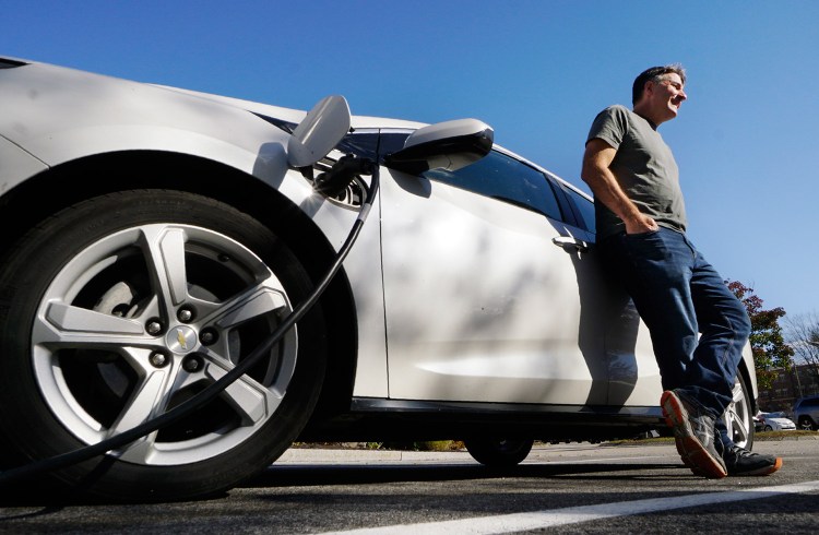 Ian Meng charges his Chevrolet Volt at the South Portland Community Center on Tuesday. Meng's house was without power so he went to the community center to charge his car. He said the storm provided important lessons, including the need to develop emergency plans in case more people start driving electric cars.