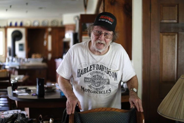 Nobel prize winner Jeffrey C. Hall speaks with a visitor at his home in Cambridge, Maine, on Monday. Hall, along with Michael Rosbash and Michael W. Young, won the $1.1 million prize for their work on finding genetic mechanisms behind circadian rhythms, which adapt the workings of the body to different phases of the day.