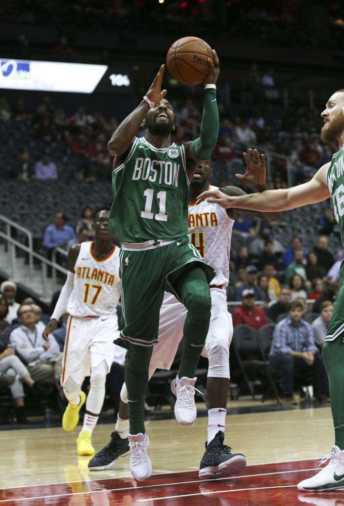 Celtics guard Kyrie Irving (11) goes up for a shot in the first half. Irving was Boston's leading scorer in the win, with 35 points.