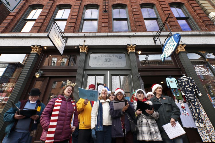 Members of the Portland Community Chorus perform outside Something's Fishy on Saturday. The store was among nearly 50 businesses participating in Shop for a Cause, with a portion of the proceeds going to Amistad, a mental health and addiction recovery center in Portland.