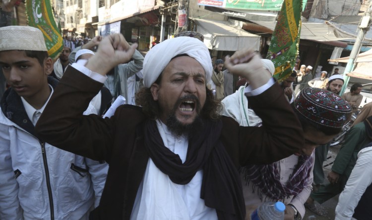 Religious group supporters rallying to express solidarity with protesters block the main highway in Peshawar, Pakistan. Elsewhere, police in riot gear launched an operation to clear a key road leading to Islamabad.