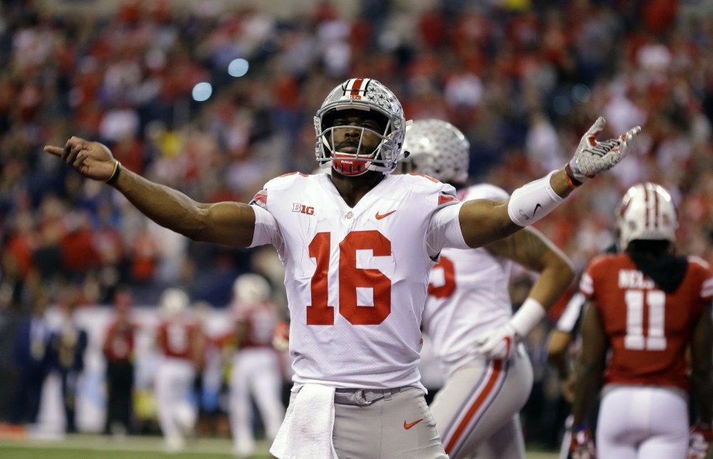 Ohio State quarterback J.T. Barrett celebrates after a 1-yard touchdown run in the first half of the Big Ten championship game Saturday night against Wisconsin. Ohio State won, 27-21.