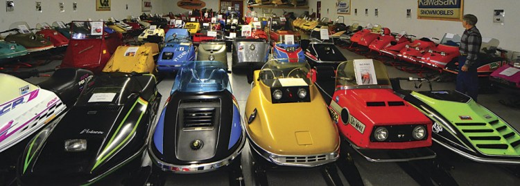 Ed Rosebrook of Lancaster, N.H., stands in a sea of vintage snowmobiles this month at Crane's Snowmobile Museum in Lancaster.