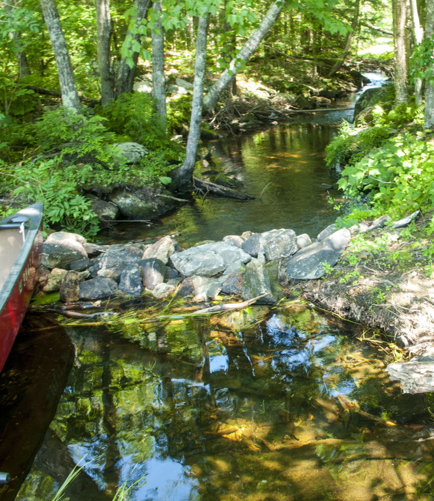 The rock impoundment on David Pond in Chesterville. A group is working on the water level problem related to the impoundment.