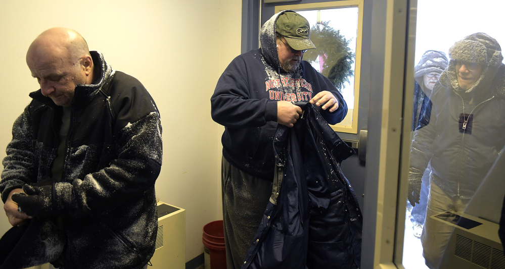 Guests come in from the cold Monday at Emmanuel Lutheran Episcopal Church in Augusta for the community dinner.