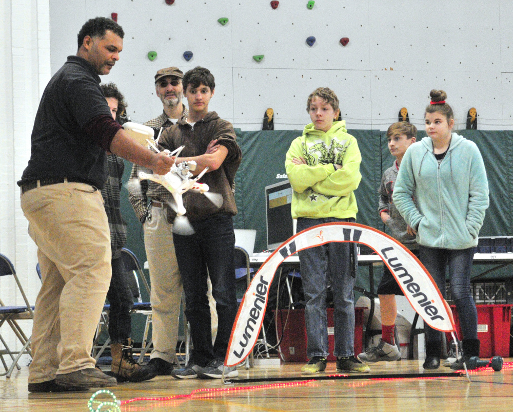 Kristopher Kleva grabs a drone out of the air during a demonstration on at The Buker Center in Augusta. Kleva got a cut on the forearm when he had to grab the drone, as it wasn't following guidance from the controller.