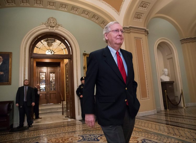 Senate Majority Leader Mitch McConnell, R-Ky., walks from the Senate chamber to his office late Friday night during votes on amendments to the Republican tax overhaul.