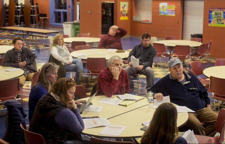 People listen to Megan Ware of the Atlantic States Fisheries Management Commission before giving their input on a proposal to make most of them record where and how they fish – how far out they go, how deep their lines are and how much they catch.