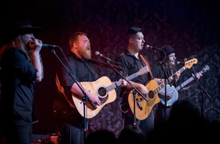 Jackson Kincheloe, on harmonica, joins Griffin Sherry, Sean McCarthy and Max Davis on stage at Port City Music Hall in Portland on Jan. 12. 