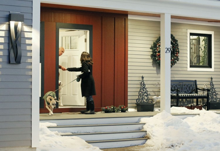 Allyson Cavaretta shakes hands with a neighbor as she goes door-to-door on Osprey Lane in York, introducing herself and her candidacy for state representative.