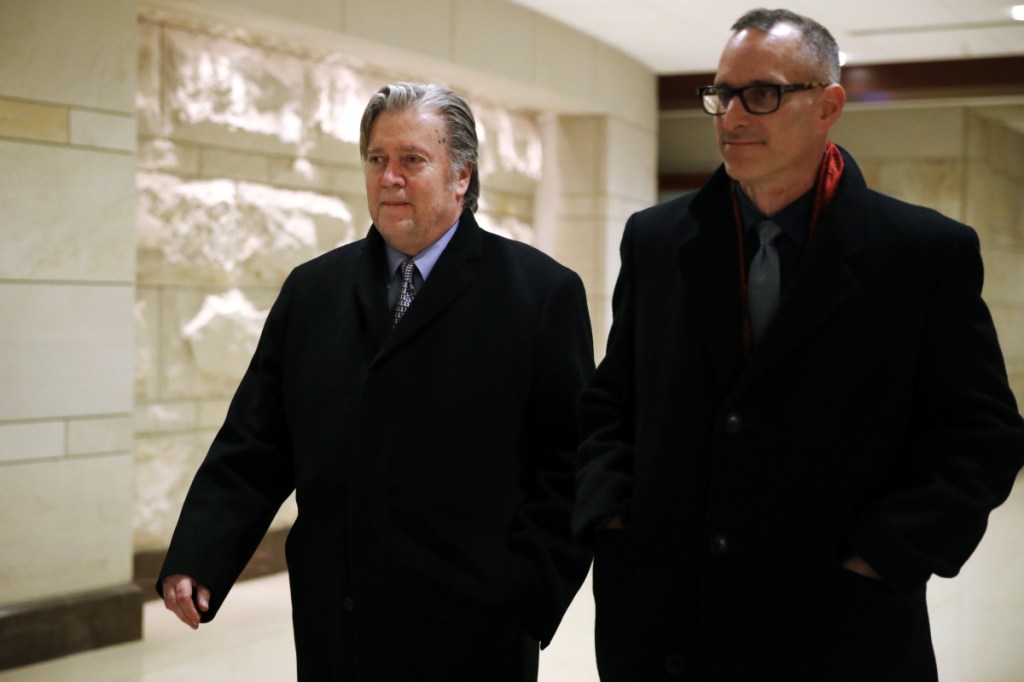 Former White House strategist Steve Bannon, left, leaves the House Intelligence Committee meeting where he was interviewed behind closed doors Tuesday.