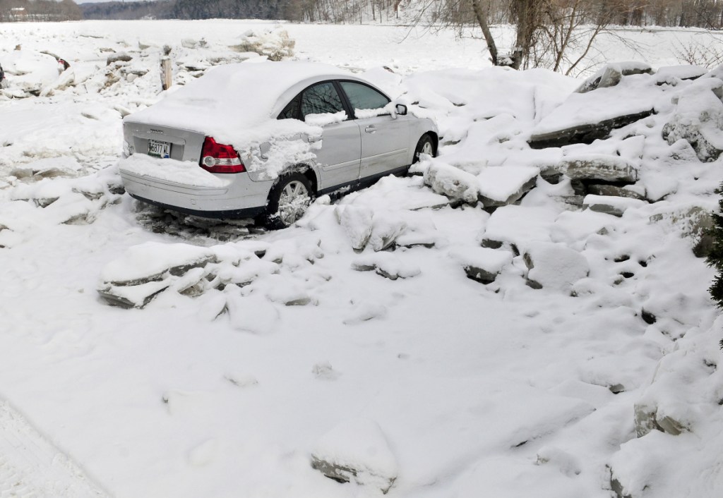 One of the last cars that was caught in floodwater last weekend was still in the Front Street parking lot surrounded by ice chunks on Friday in Hallowell.