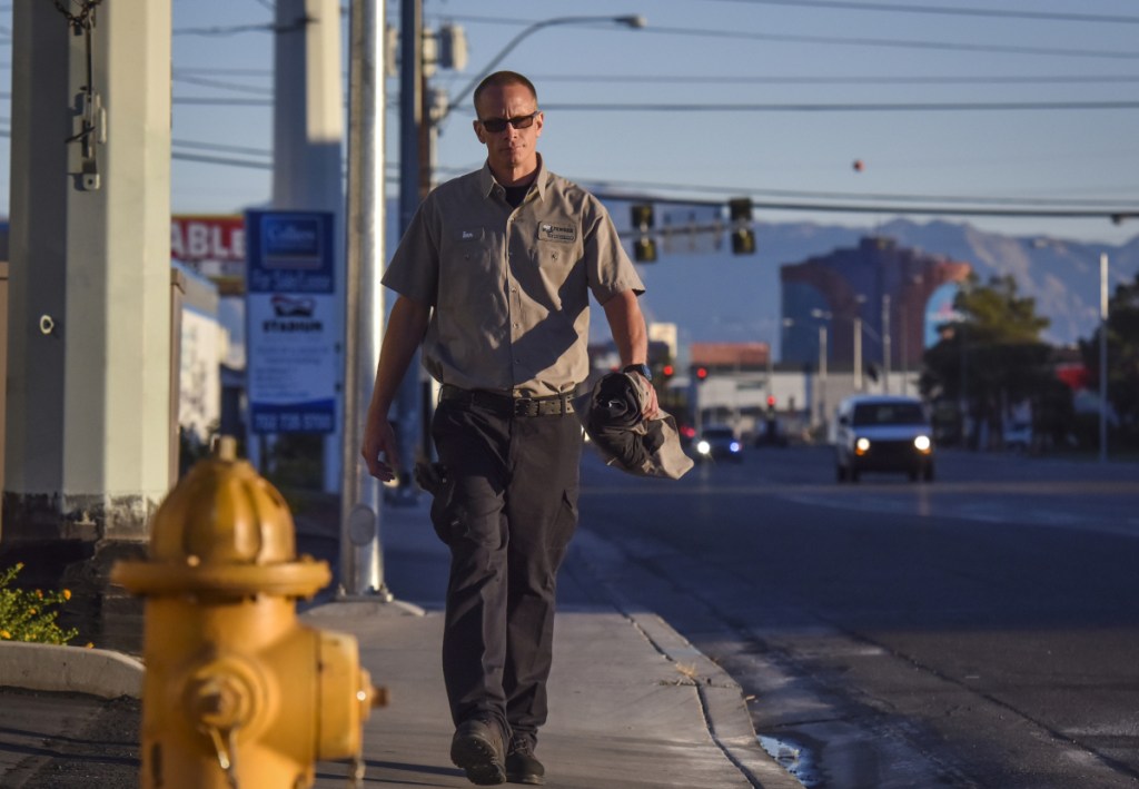 Ian Black, who is currently an inmate at Casa Grande Transitional Housing, walks to his job at Pioneer Overhead Doors in Las Vegas last year.
At left, Black loads a truck in preparation for a day of installing garage doors