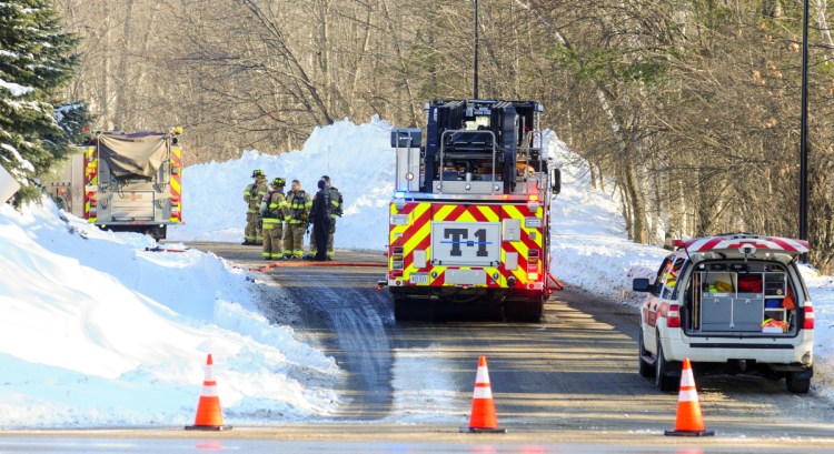 Augusta firefighters confer after putting out a propane tank fire behind American Eagle Outfitters Tuesday morning.