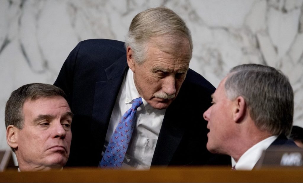 From left, Vice Chairman Mark Warner, D-Va., Sen. Angus King, I-Maine, and Chairman Richard Burr, R-N.C., speak together during a Senate Select Committee on Intelligence hearing on worldwide threats on Tuesday in Washington.