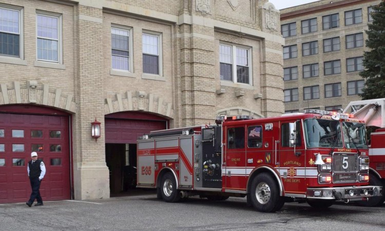 Portland Fire Chief David Jackson watches Engine 5 prepare for a call Feb. 12 at the Central Station, where the bay doors are barely wide enough for modern equipment.