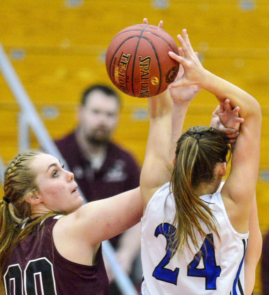 Richmond's Sydney Tilton, left, and Old Orchard Beach's Meghan LaPlante battle for a rebound. Tilton had nine points and 10 rebounds in the Bobcats' 33-30 win.