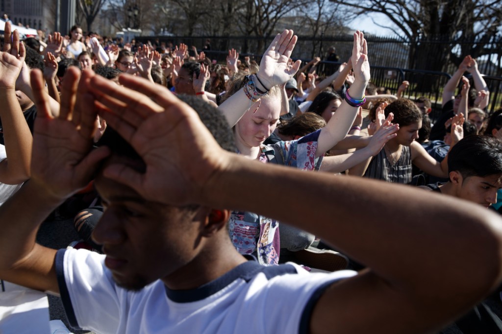 Demonstrators listen as the names of the victims of the Florida school shooting are read during a student protest for gun-control legislation in front of the White House on Wednesday in Washington.