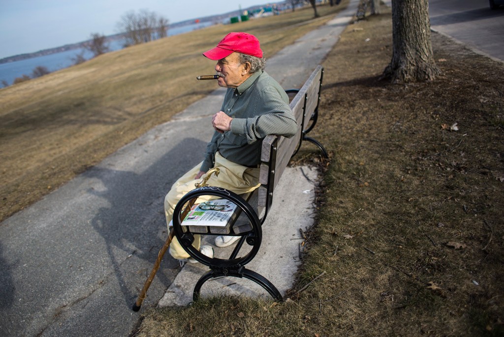 Paul Carter of Portland takes advantage of Wednesday's spring-like weather to sit and smoke a cigar on the Eastern Promenade. Portland set another temperature record.