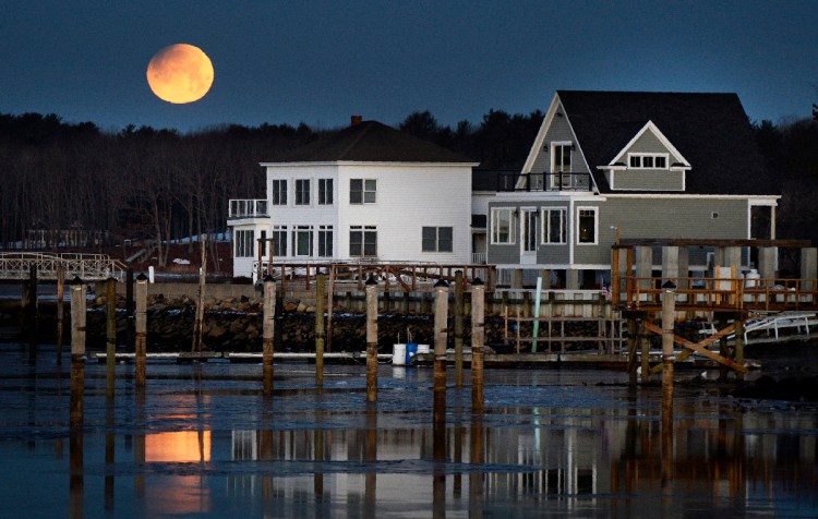 A super blue moon sets over over the Saco river in Camp Ellis at the start of it's eclipse Wednesday, January 31, 2018. Staff photo by Shawn Patrick Ouellette