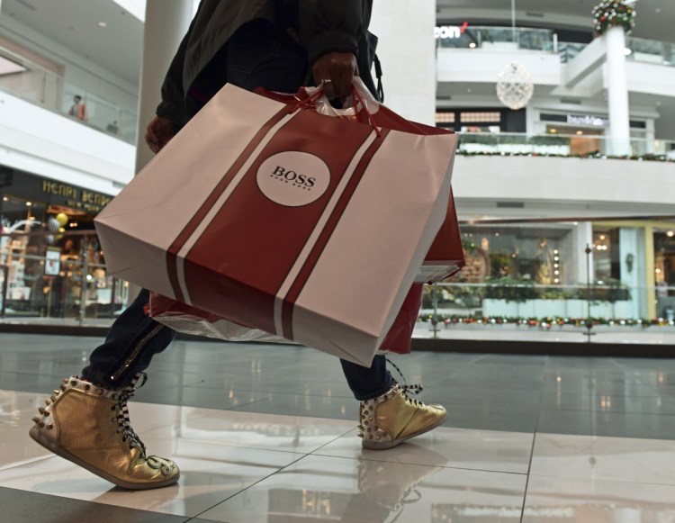 People shop at the Pentagon City Mall in Arlington, Va., in December. The Commerce Department issued its January report on consumer spending Thursday.