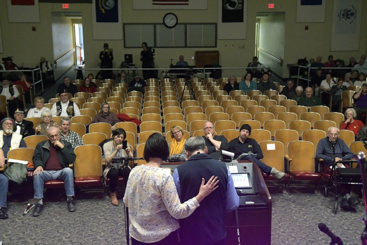 Togus VA employee Courtney Oliver, left, helps veteran Stanley Munson recite one of his original poems at the Maine Veterans Creative Arts Competition.