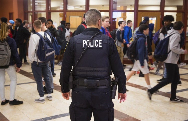 South Portland High School resource officer Alfred Giusto stands outside the main office as students exit for the weekend on Friday.