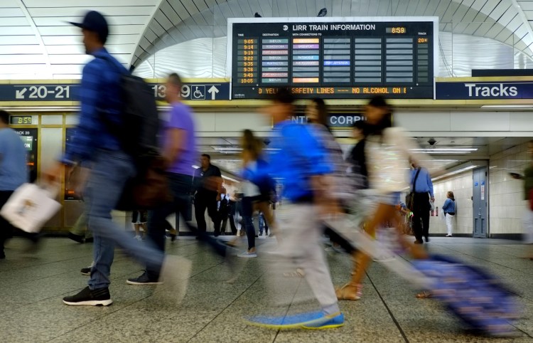 Commuters rush through New York's Penn Station last year. President Trump is threatening a veto over federal funding for a long-planned upgrade to New York's commuter system.