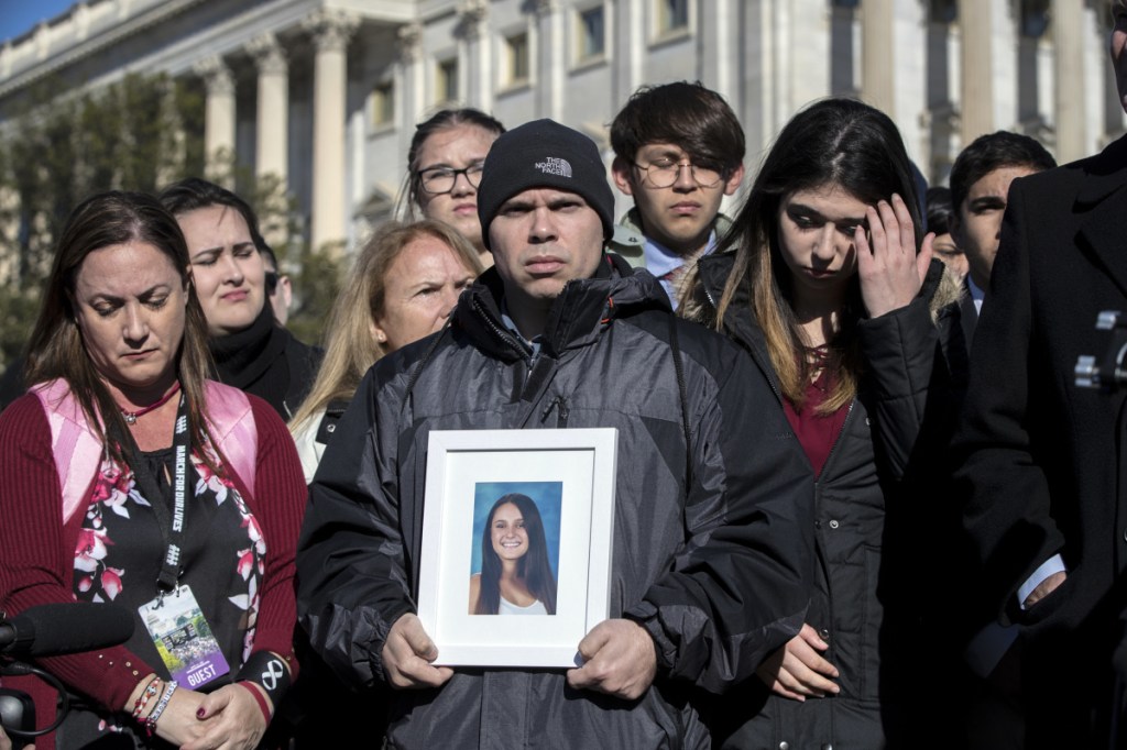 Ilan Alhadeff, joined at left by his wife, Lori, holds a picture of their daughter, Alyssa Alhadeff, 14, who was killed at Marjory Stoneman Douglas High School in Parkland, Fla.. Lawmakers and student activists rallied in support of gun control in Washington on Friday, a day before the March for Our Lives.