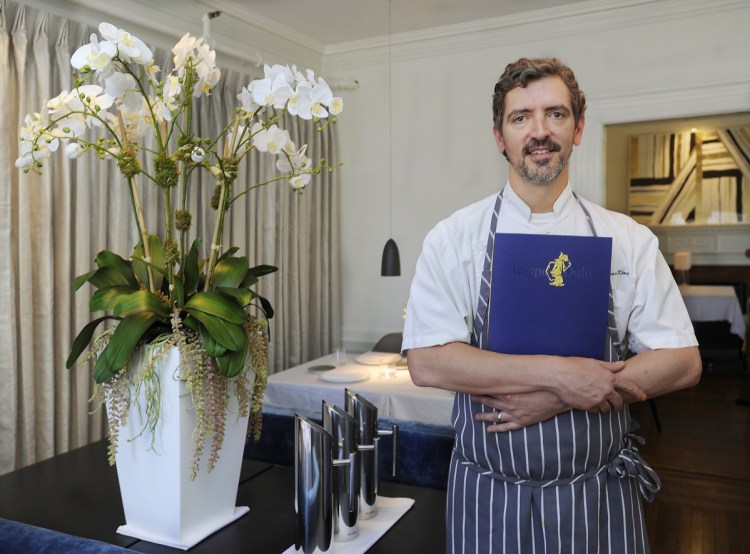 Holding the menu is Lawrence Klang, when he was chef at Portland's Tempo Dulu. Klang died unexpectedly in his sleep in Florida. A cause of death was not given.