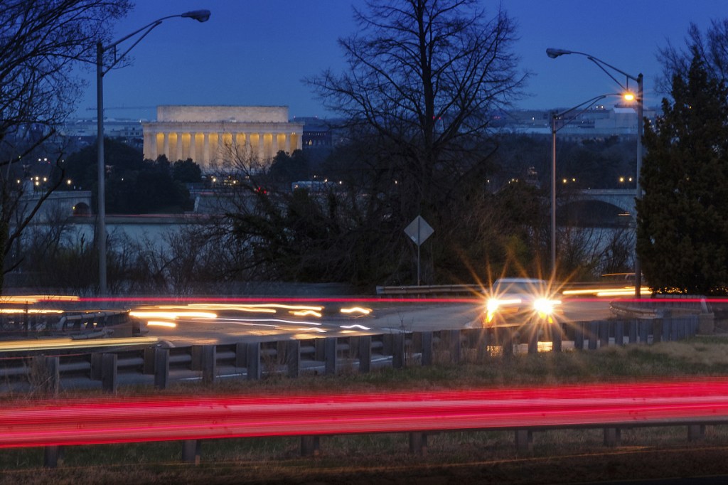 Traffic streaks along U.S. Highway 50 early in the morning Friday across the Potomac River from Washington in Arlington, Va. The Trump administration is expected to announce that it will roll back automobile gas mileage and pollution standards that were approved during the Obama administration.