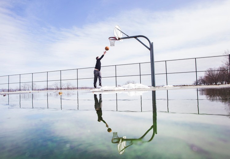 Dakota Parkman of Portland makes the most of the weather while shooting hoops at the Eastern Promenade on March 28, 2018. "It's just nice that it is finally warming up", he said.