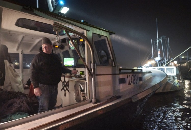 Lobsterman John Williams, 63, of Stonington steers his boat away from the dock early Friday. Four years ago, Williams and his wife had a $750 health insurance deductible; today it's $5,400. The couple look forward to turning 65, when they'll be Medicare-eligible.