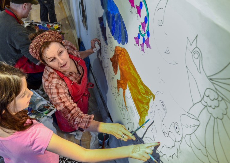 Elise Inch, 9, left, gets advice from Jen Greta Cart on how to blend paint colors to fill in a fox's face Saturday in the former Harlow Gallery space in downtown Hallowell. Cart was teaching painting techniques as they worked together.