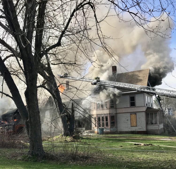 A fire burns the three-story building at 10 West St. in Gardiner on Monday afternoon.