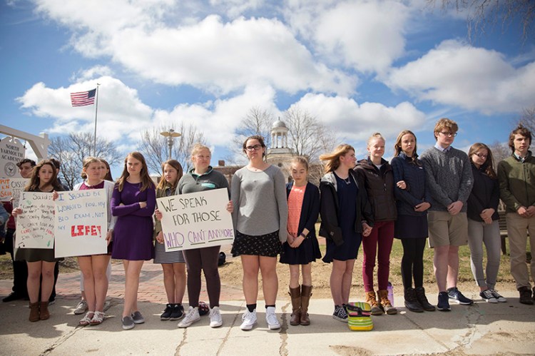 Over 100 North Yarmouth Academy students from the middle and upper school line Main Street in Yarmouth during a student-organized silent walkout that lasted for 13 minutes to honor the 13 lives lost in the Columbine shooting on April 20, 1999. 