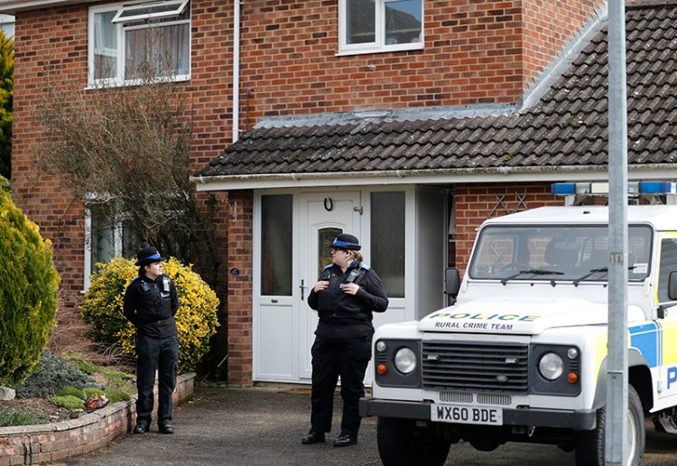 Police officers stand outside the house of former Russian double agent Sergei Skripal in Salisbury in Marcxh. British police say they believe a Russian ex-spy and his daughter first came into contact with a military-grade nerve agent at their front door. 