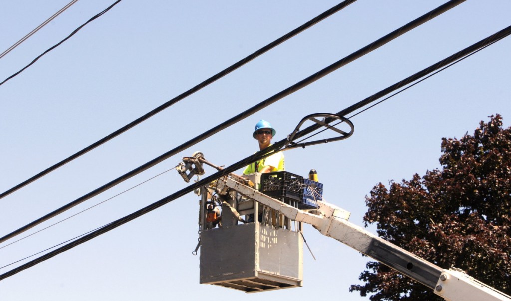 Ericson Estes of NextGen runs a line to support fiber-optic cable in Wells in 2012. Three Maine projects will take part in a pilot program designed to spur investment in high-speed internet in rural and under-served areas.