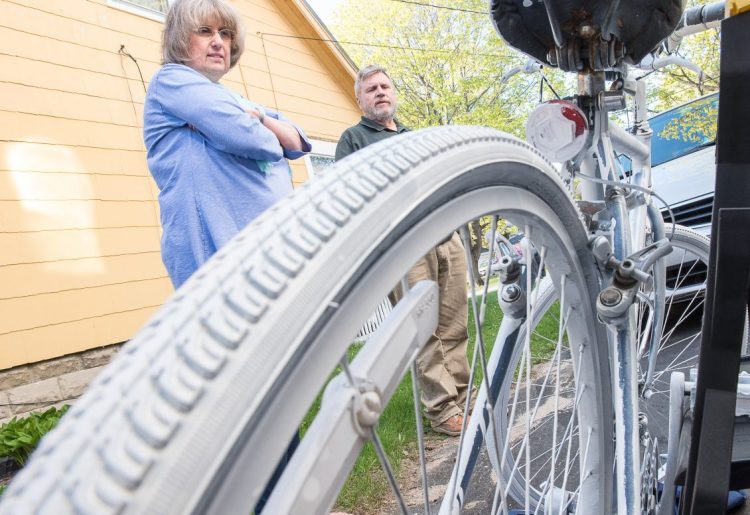 Suzanne and Bob Barton of Westbrook with the "ghost bike" honoring their son, killed by a drunken driver in 1998. Similar painted memorials can be found across the country.