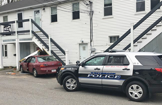 The scene where a stolen car crashed into a building at  9 Giles St. in Westbrook.