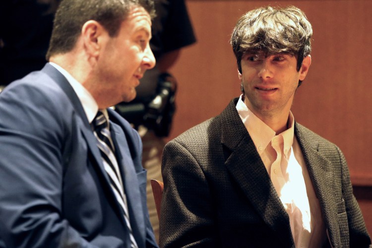 John D. Williams, right, who is accused of killing Somerset County sheriff's Cpl. Eugene Cole, talks with lawyer Verne Paradie before pleading not guilty Tuesday during an arraignment hearing at Cumberland County Courthouse. (Staff photo by Ben McCanna)