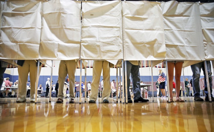 Falmouth residents stand booth-to-booth Tuesday during a busy Election Day at the local high school. Despite dire predictions, ranked-choice voting didn't cause widespread confusion among Maine voters.