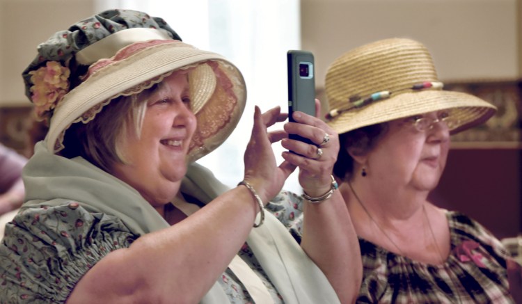 Lyn Rowden, left, and Susan Weber take part in the annual meeting, where Rowden did a retelling of the female society's 200-year history.