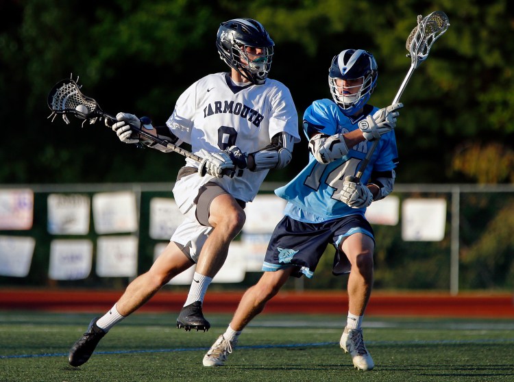 Yarmouth's Cooper May maneuvers around York's John Bychok.