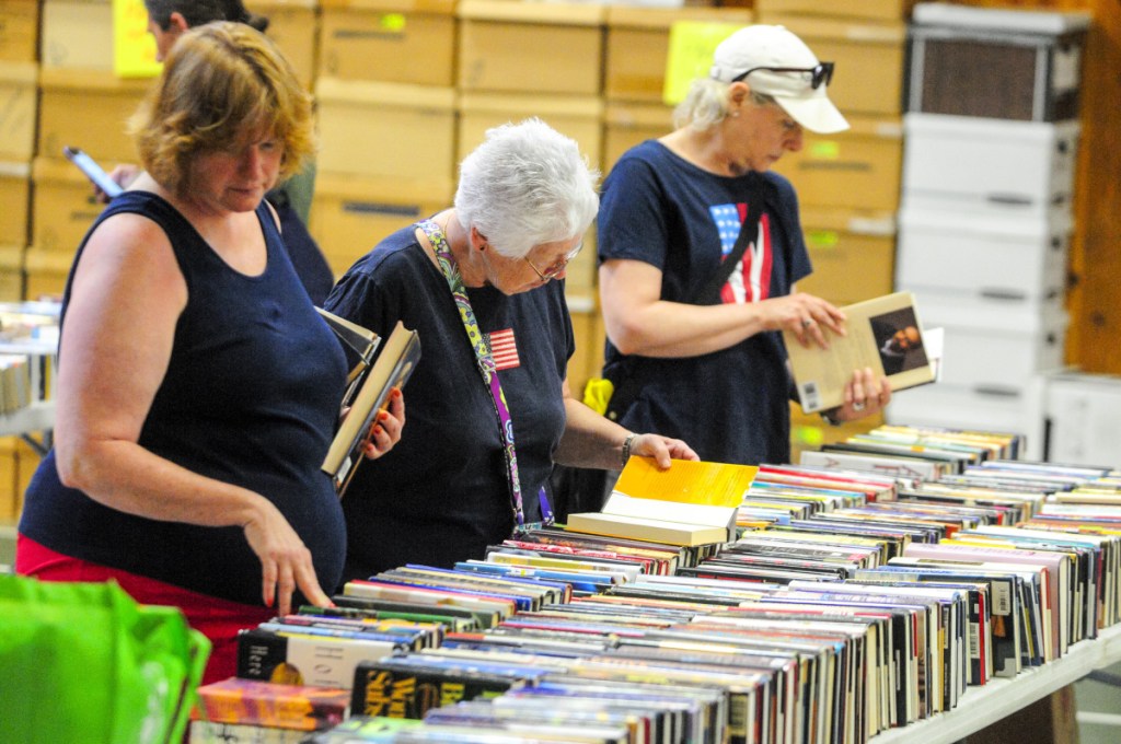 Shoppers look for books Wednesday during the annual Friends of Belgrade Library book sale in the Center for All Seasons in Belgrade.