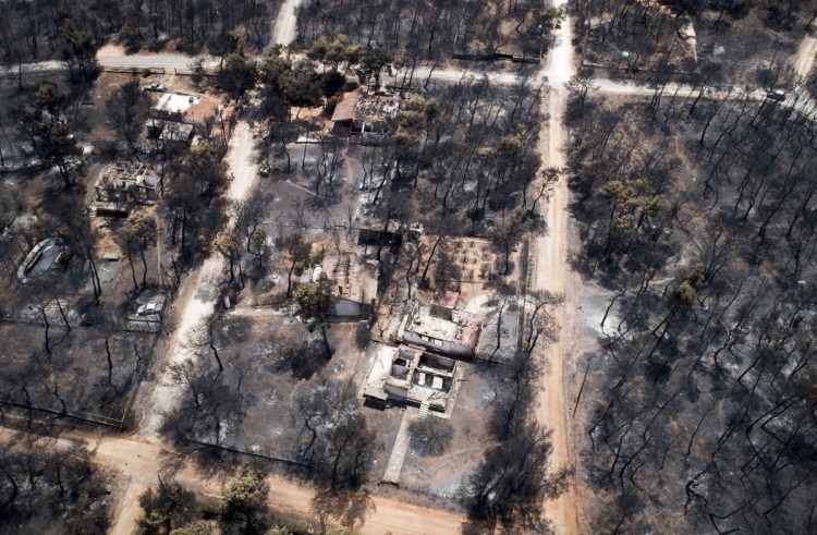 The death toll rose to 82 following Monday's wildfire east of the Greek capital that left behind a scorched landscape.